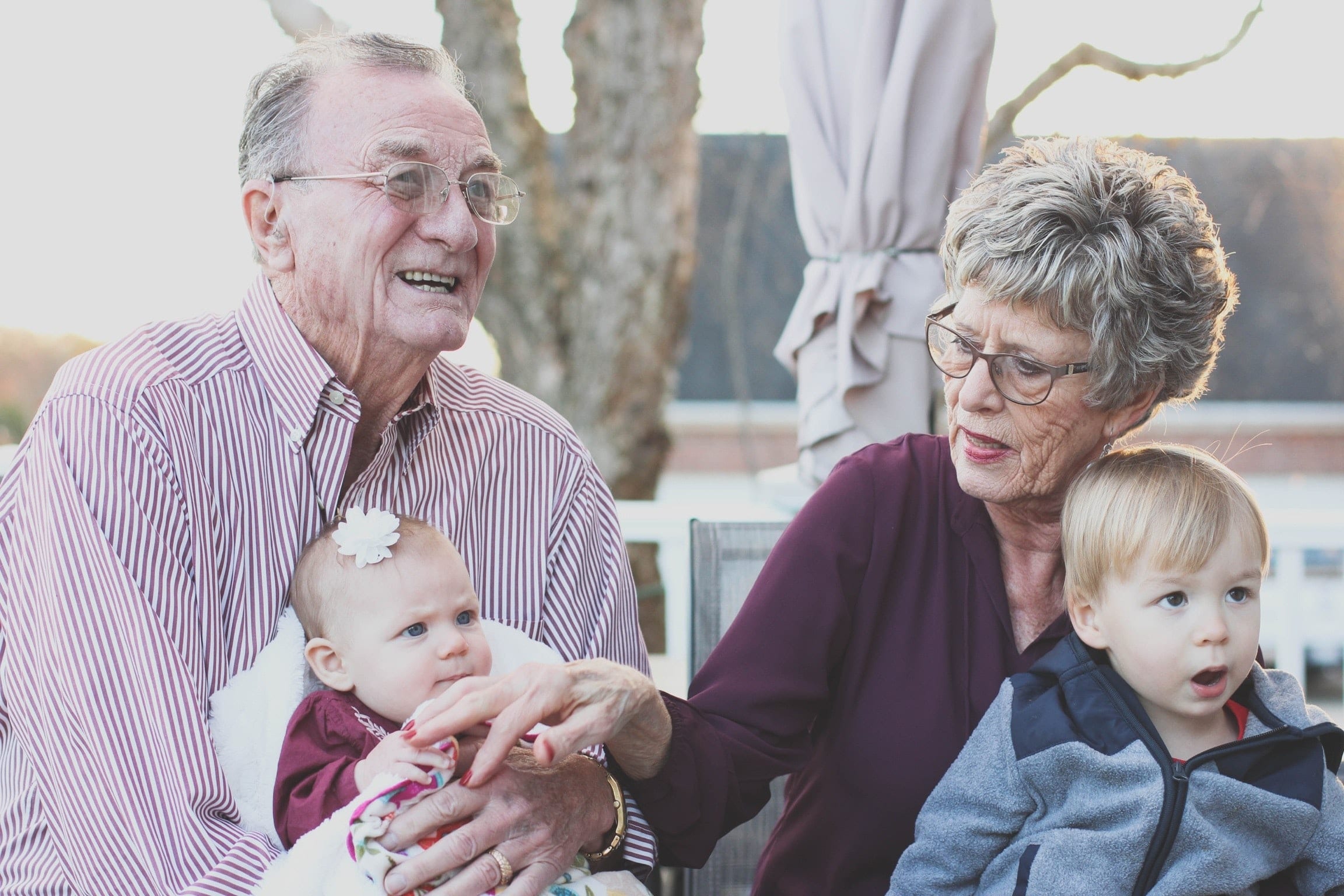 Grandparents holding small children