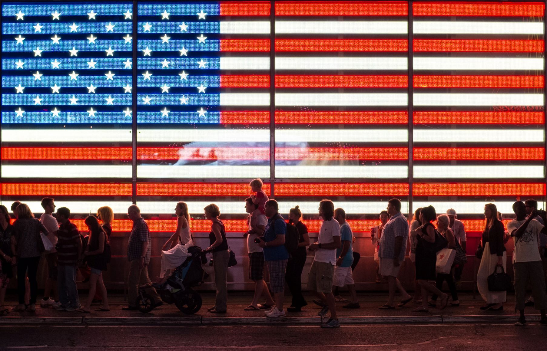 people in front of USA flag display