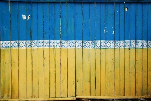 Ukrainian flag painted on a wooden fence