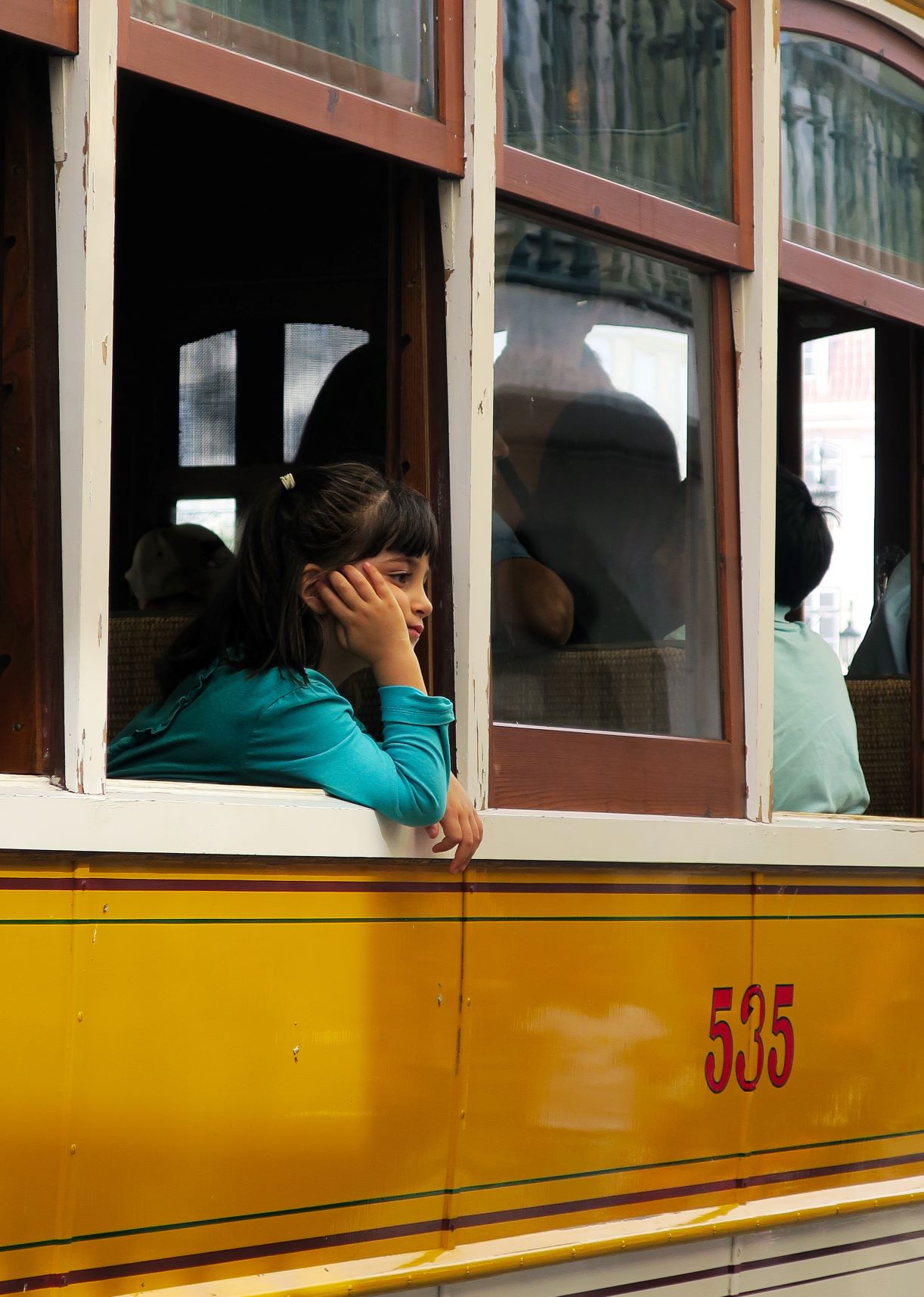 child in window of Portuguese tram